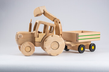 wooden kids tractor toy with trailer isolated on white background, close view 