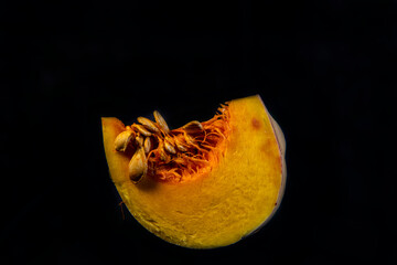 still life with fruits and yellow pumpkin on a black background