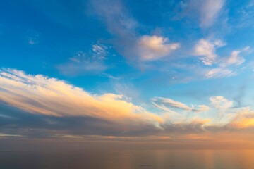 Fototapeta na wymiar Beautiful sunset sky with clouds, the horizon merges with the sea, backgrounds . High quality photo.