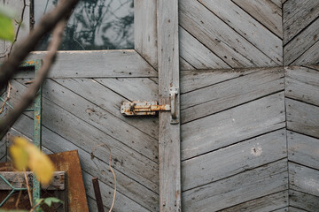 Rusty entrance close up with wooden door in old country home. Countryside dated house. Rustic style  building. Wood texture background. 