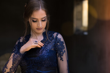 Close-up of a beautiful girl in glamorous ultramarine dress. Ready for her prom