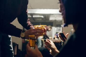A man brings girls alcoholic shot glass cocktails.