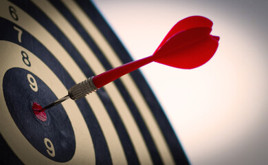 red darts arrows in the center of dartboard with blue sky background, in the business goal concept
