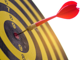 red darts arrows in the center of dartboard with blue sky background, in the business goal concept