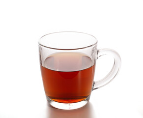 transparent mug with black tea on a white background.
