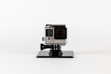 Action camera, compact sports camera in waterproof housing and on stand to keep it stationary