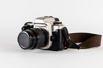 Old photo camera, analog reflex camera or roll camera with old brown strap. Professional camera.