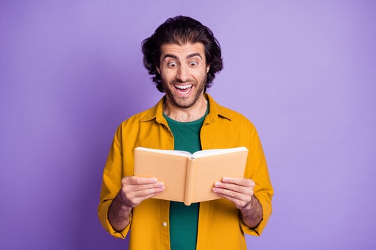 Photo of young attractive man hold book notebook read amazed excited happy smile isolated over purple color background
