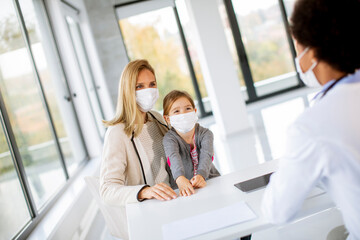 Mother with his little daughter at the pediatrician examination