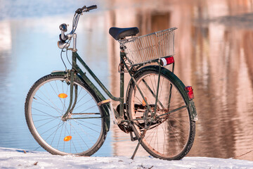 Naklejka na ściany i meble An old bicycle left by the pond