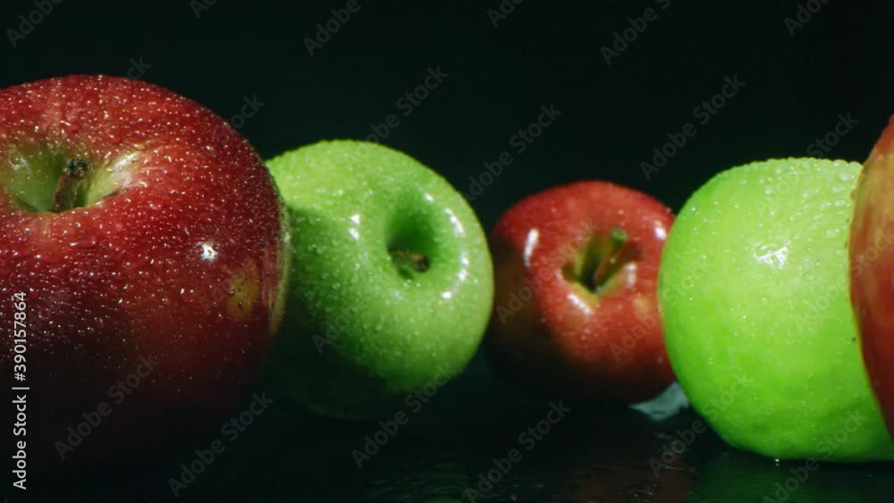 Poster zoom in macro closeup of colorful ripe apples freshly picked and washed lying on black surface