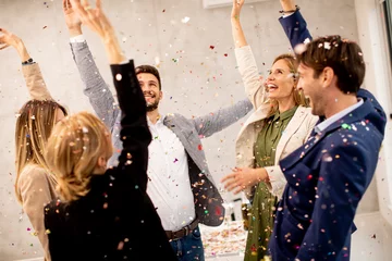 Foto op Plexiglas Group of business people celebrating and toasting with confetti falling in the office © BGStock72