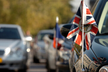 British Ambassador's car with the flag of the Union Jack with the Royal Coat of Arms, the official coat of arms of the British monarch, used by British Embassies overseas