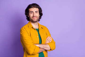 Photo of young confident multiethnic brown hair man folded hands isolated over purple color background