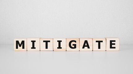MITIGATE word made with building blocks, business concept.