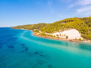 Aerial drone view of Fourka Skala sea and pine forest in Halkidiki, Greece