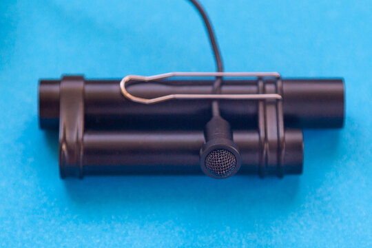 Lavalier microphone with long cable and power module. Close-up