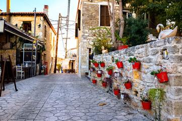 Fototapeta na wymiar Street with flowers in Afitos, Halkidiki, Greece