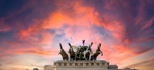 Pink dramatic skies during sunset over the bronze horses at corte di cassazione supreme court in Rome, italy. - obrazy, fototapety, plakaty