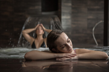 Young women relaxing in water in spa center