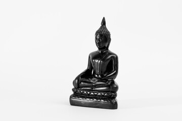 Black Indian Buddha sculpture on a white background.