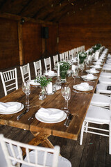 decorated wedding wood table with white chairs