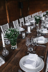 decorated wedding wood table with white chairs