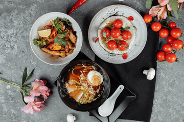 three-course business lunch. cherry tomatoes with tofu mousse, thai rice with chicken and vegetables, asian noodle soup, ramen with chicken