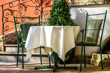table and chairs at a sidewalk restaurant