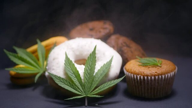 Cannabis edibles. CBD oil sweets. Marijuana leaf. Smoke effect