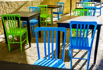 table and chairs at a sidewalk restaurant