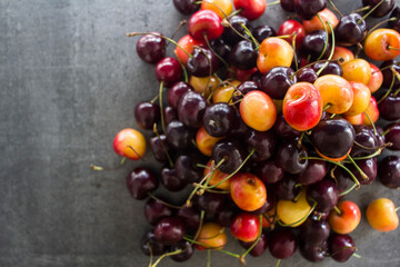 Sweet cherry on a table. Vibrant color of juicy berries. Summer fruits close up photo. Healthy eating concept. 