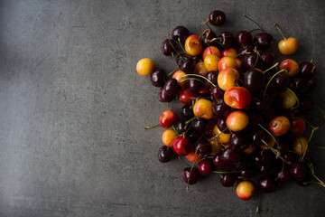 Sweet cherry on a table. Vibrant color of juicy berries. Summer fruits close up photo. Healthy eating concept. 