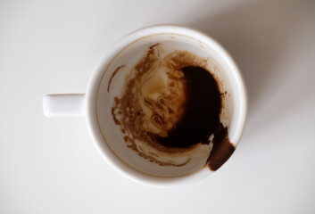 Coffee grounds in white cup on white background isolated top view