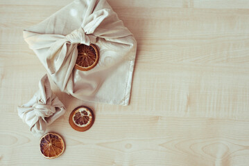 Christmas eco-friendly gift wrapping in traditional Japanese Furoshiki style, present wrapping with...