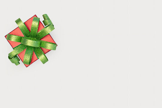 red christmas gift with green bow on white background
