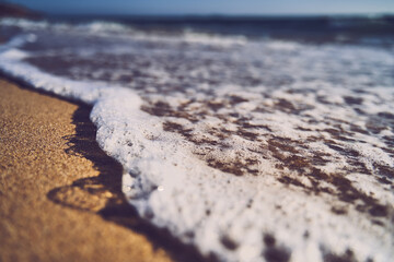 Closeup shot of foamed waves in the beach Zahara de Los Atunes, Cadiz, Spain