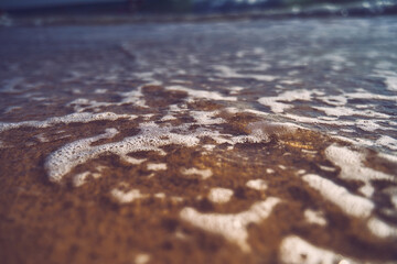 Closeup shot of foamed waves in the beach Zahara de Los Atunes, Cadiz, Spain