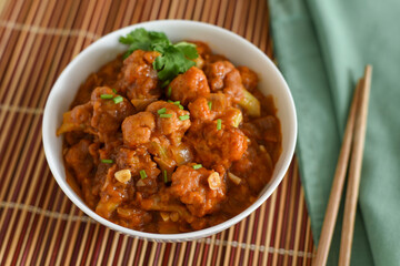 Gobi Manchurian dry and with gravy , Gobi 65 popular street food Delhi India made of cauliflower florets, Veg Manchurian chilly gobi Indo Chinese cuisine side dish of paratha , chapati , roti , Pulao