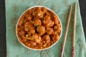 Gobi Manchurian dry and with gravy , Gobi 65 popular street food Delhi India made of cauliflower florets, Veg Manchurian chilly gobi Indo Chinese cuisine side dish of paratha , chapati , roti , Pulao