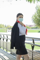 Vertical shot of a Caucasian woman wearing a sanitary mask outdoors-concept of the new normal