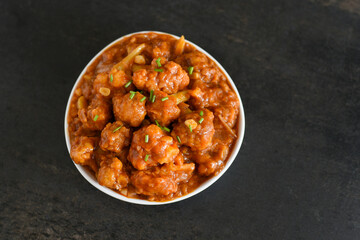 Gobi Manchurian dry and with gravy , Gobi 65 popular street food Delhi India made of cauliflower florets, Veg Manchurian chilly gobi Indo Chinese cuisine side dish of paratha , chapati , roti , Pulao