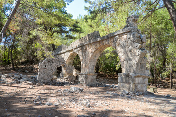 Fototapeta na wymiar The ruins of the ancient aqueduct at Phaselis in Tekirova Kemer. Phaselis is also an ancient port city. Antalya province Turkey.