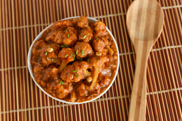Gobi Manchurian dry and with gravy , Gobi 65 popular street food Delhi India made of cauliflower florets, Veg Manchurian chilly gobi Indo Chinese cuisine side dish of paratha , chapati , roti , Pulao