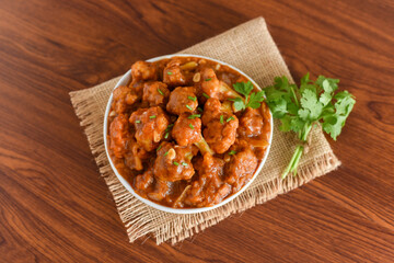 Gobi Manchurian dry and with gravy , Gobi 65 popular street food Delhi India made of cauliflower florets, Veg Manchurian chilly gobi Indo Chinese cuisine side dish of paratha , chapati , roti , Pulao
