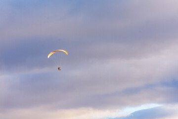 Paragliding against snow-capped Andes mountains during winter season in Esquel, Patagonia, Argentina