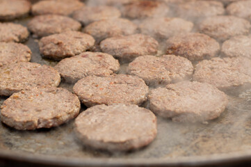 Chopped beef steak is fried to make hamburgers.