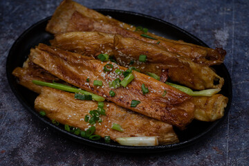 Teriyaki yuba tofu skins ribs on dark plate