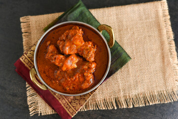 Spicy red chicken curry. Goan style chicken vindaloo. Butter chicken Murgh Makhani curry roast hot and spicy gravy dish Dhaba Punjab, India. North Indian non-vegetarian cuisine Garam Masala. tikka