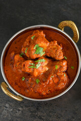 Spicy red chicken curry. Goan style chicken vindaloo. Butter chicken Murgh Makhani curry roast hot and spicy gravy dish Dhaba Punjab, India. North Indian non-vegetarian cuisine Garam Masala. tikka